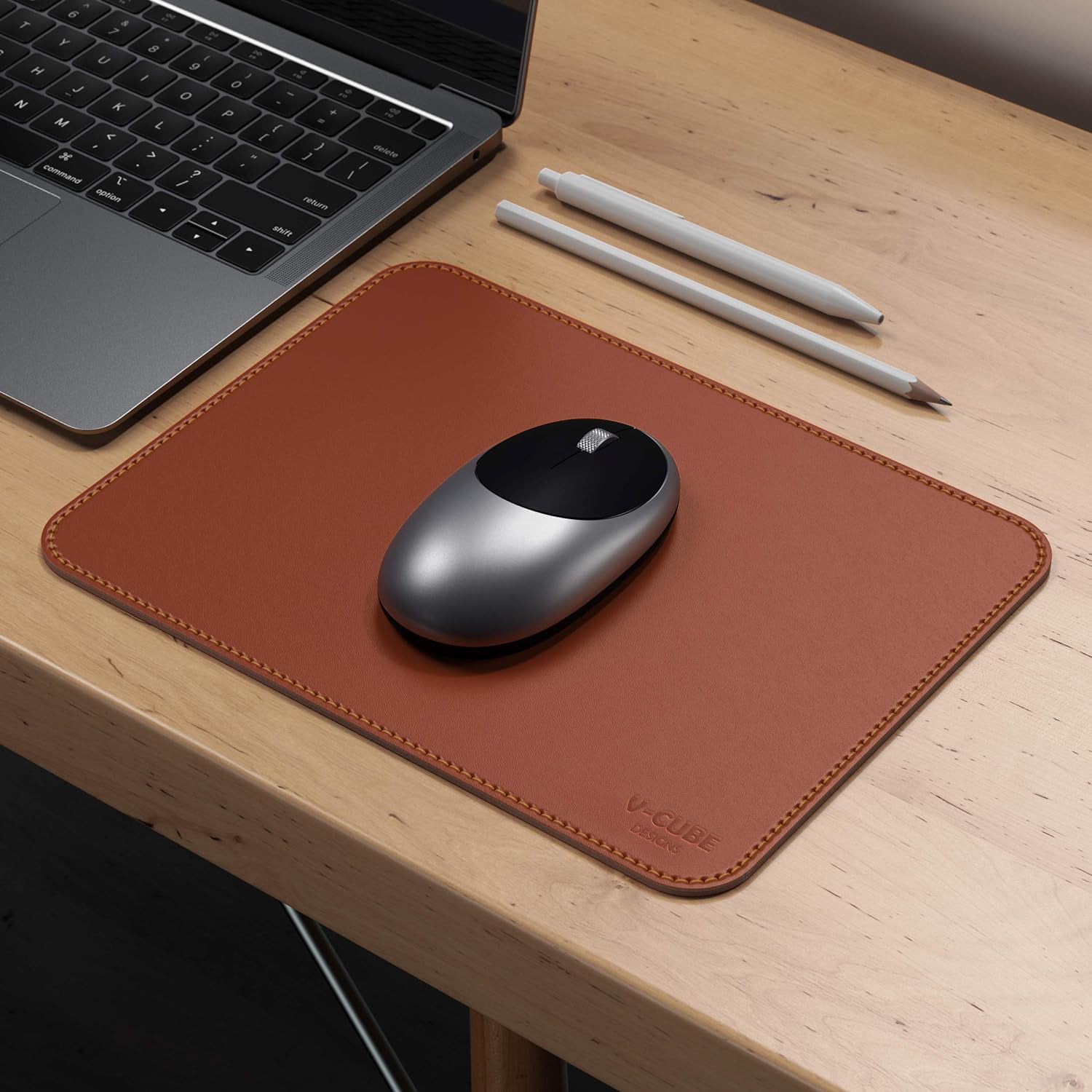 Close-up of stitched edges and 2.4mm padding on a tan premium mouse pad.