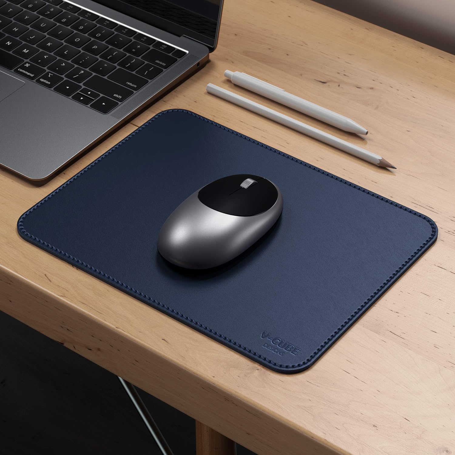 Close-up of a desk mouse pad blue color showing reinforced stitched borders and fine grain texture.